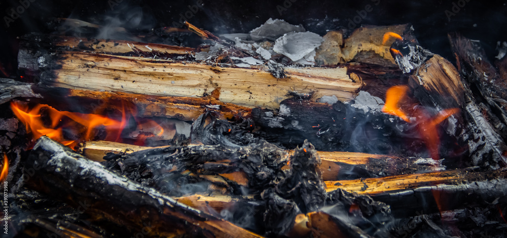 Firewood and coals burn in flames Firewood and coals burn in flames