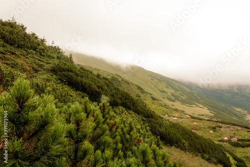 Carpathian mountains in summer fog, the area near Lake Brebeneskul, rain and fog in the mountains. photo