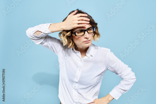Business woman in a light shirt on a blue background gestures with her hands emotions model work © SHOTPRIME STUDIO