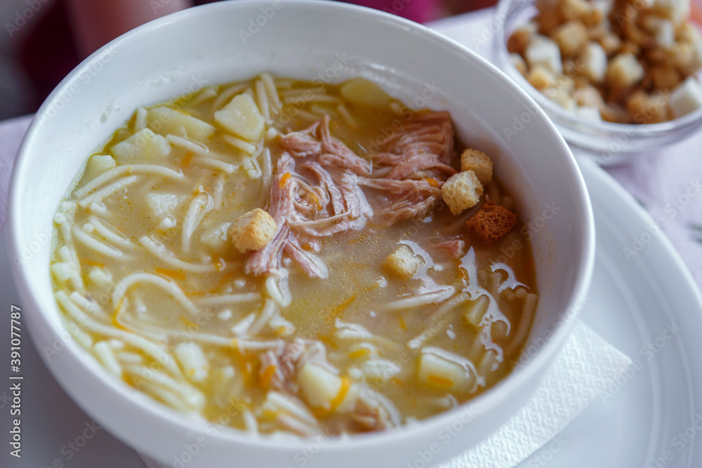 A Cup of soup with croutons of potatoes, pasta, meat. Close up A Cup of soup with croutons of potatoes, pasta, meat. Close up