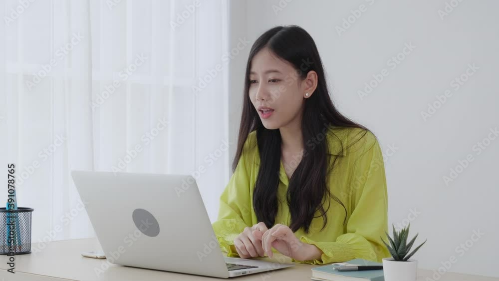 Young asian business woman using laptop computer for video conference online with social distancing, businesswoman working with video call, new normal, communication and work from home concept. Young asian business woman using laptop computer for video conference online with social distancing, businesswoman working with video call, new normal, communication and work from home concept.