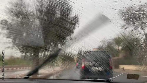 car wipers cleaning the windshield during a rainy day