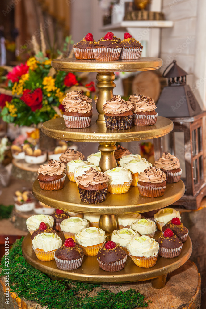Wedding cake of cupcakes with flowers at reception