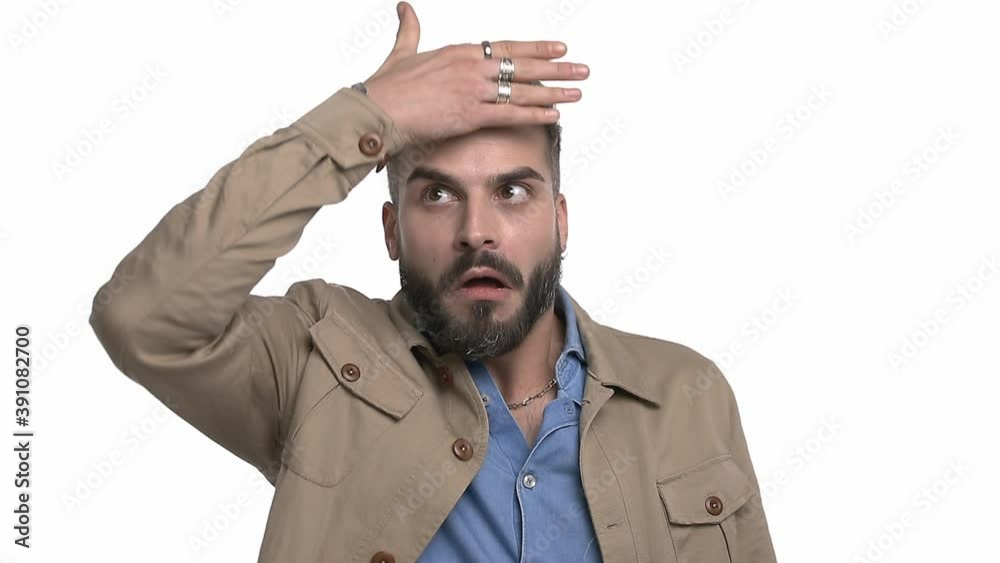 expressive young man in denim shirt switching feelings by hand, acting like a mime artist, grimacing, having fun, making funny faces and standing isolated on white background in studio expressive young man in denim shirt switching feelings by hand, acting like a mime artist, grimacing, having fun, making funny faces and standing isolated on white background in studio