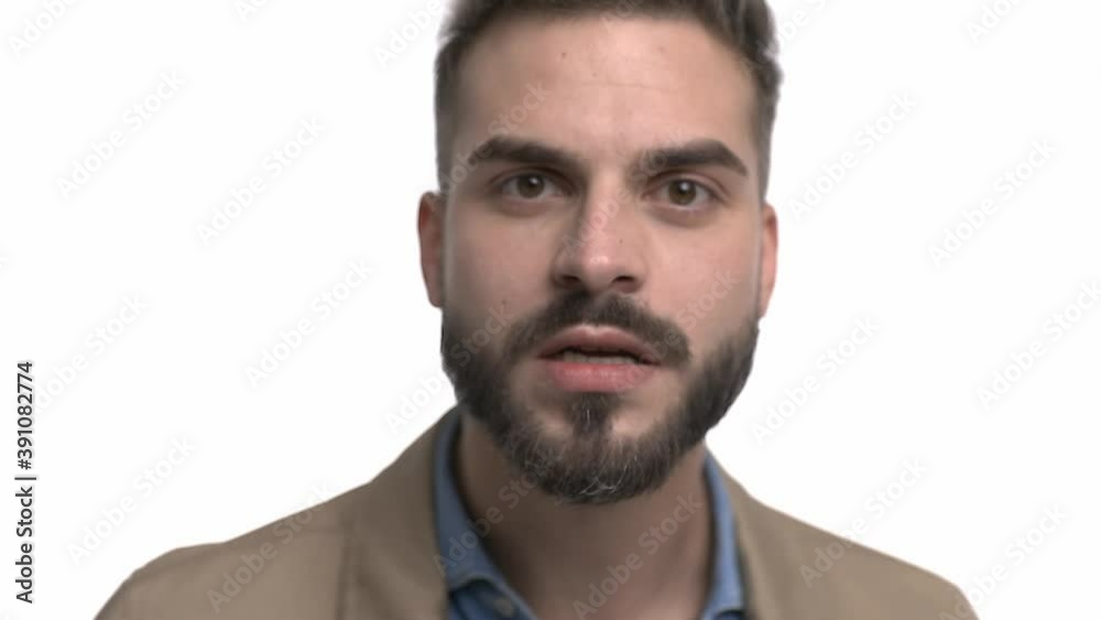 angry young man in denim shirt screaming, switching moods, laughing and clapping, standing isolated on white background in studio angry young man in denim shirt screaming, switching moods, laughing and clapping, standing isolated on white background in studio