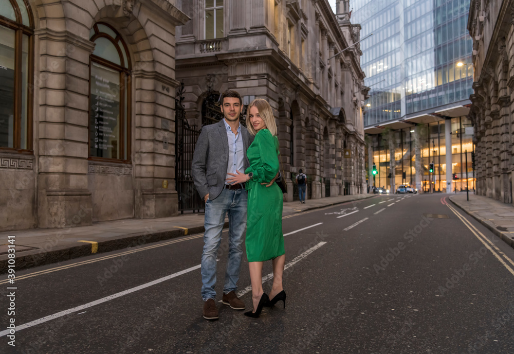 Young flirty couple posing on a street of City in London, UK Young flirty couple posing on a street of City in London, UK