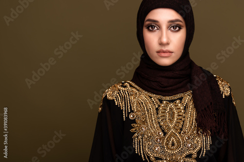 Muslim woman in hijab. Portrait of a young arab girl in traditional dress. 