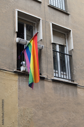 modern facade with twin balconies and on one of them the rainbow flag