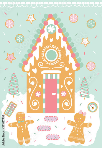 Decorated gingerbread house, man, and cookies in the snow with christmas trees.