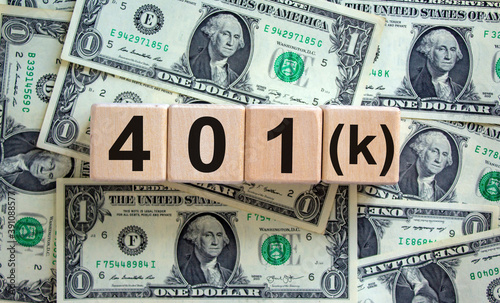 Concept text '4O1k' on cubes on a beautiful background from dollar bills. Business concept. Copy space.