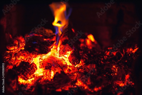 Abstract background with glowing embers of red color. Hot coals of burning wood.