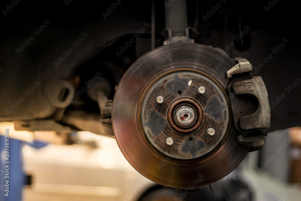Picture of front axle and disc brakes, condition through use, rust scratch. The wheels were removed for car maintenance and changing wheels-tires Picture of front axle and disc brakes, condition through use, rust scratch. The wheels were removed for car maintenance and changing wheels-tires