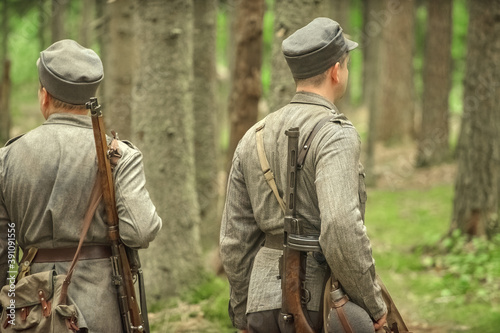 Finnish soldiers of the second world war in the forest with machine guns and rifles on their shoulders