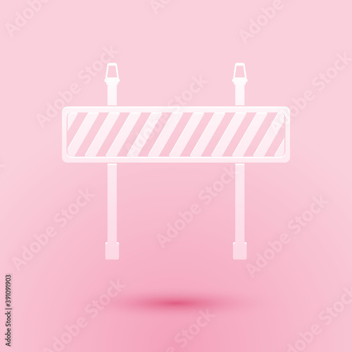 Paper cut Road barrier icon isolated on pink background. Fence of building or repair works. Hurdle icon. Paper art style. Vector.