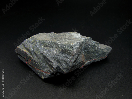 Sample of raw gray magnetite on a black background