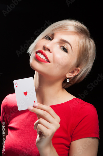 Beautiful blond girl showing a poker card