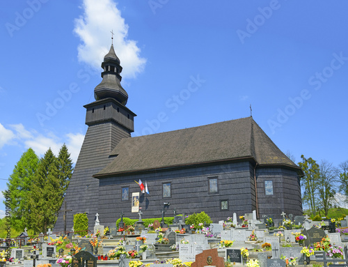 Wooden church with cemetery in Konczyce Wielke village in Silesia. Church belongs to a set of exquisite wooden churches Cieszyn Silesia, Poland photo