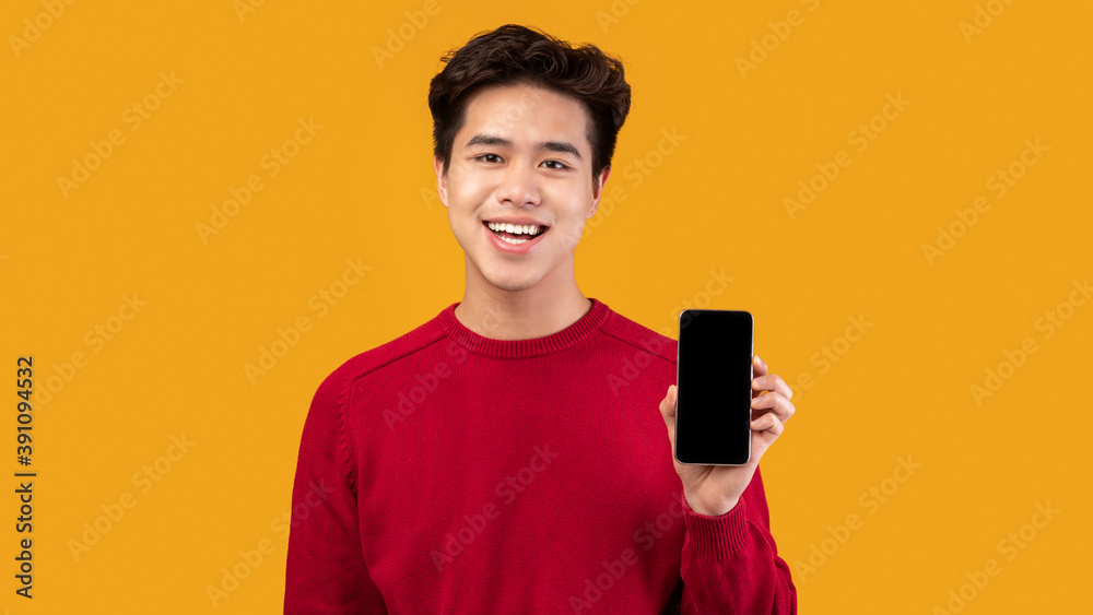 Asian man showing blank cell phone screen Asian man showing blank cell phone screen