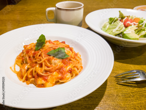 Spaghetti with tomato sauce and cheese topping served with an avocado salad and soup