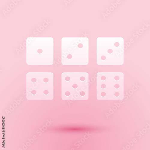 Paper cut Set of six dices icon isolated on pink background. Paper art style. Vector.