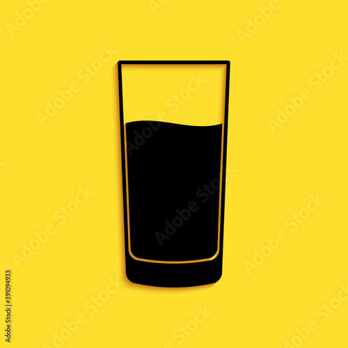 Black Glass with water icon isolated on yellow background. Soda glass. Long shadow style. Vector.