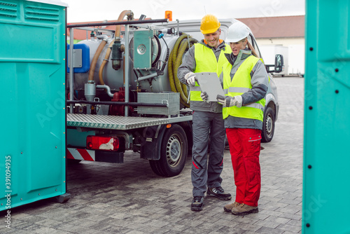 Workers doing some logistics in the rental toilet business