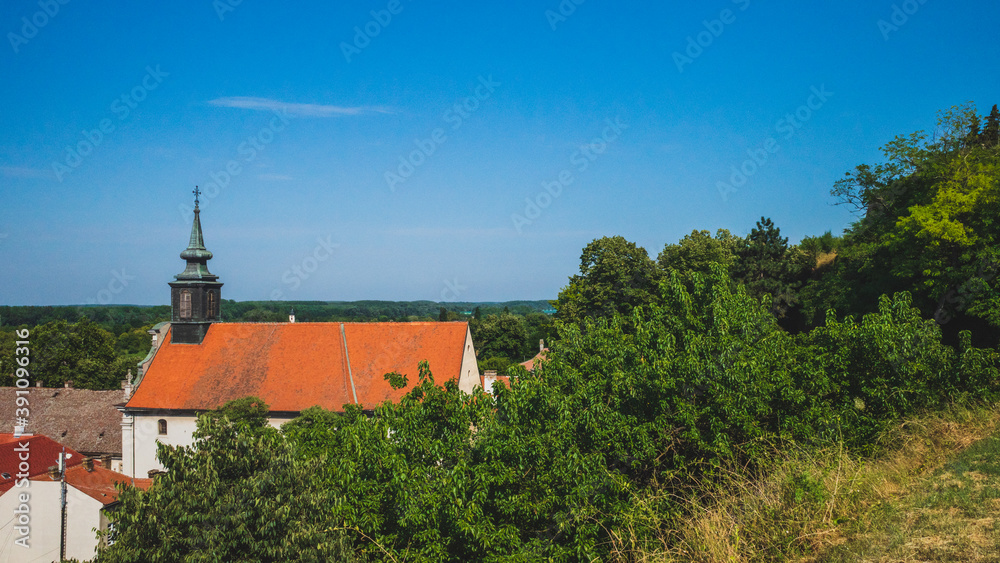 Church with tower in the town of Petrovaradin under blue sky, Novi Sad, Serbia