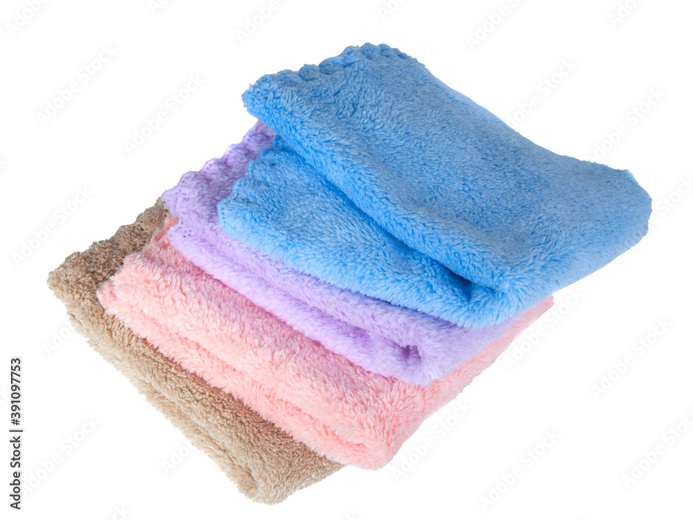Different multicolor fluffy fabric towel isolated on the white Different multicolor fluffy fabric towel isolated on the white