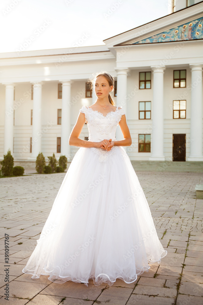 Portrait of a young woman in a white ball gown