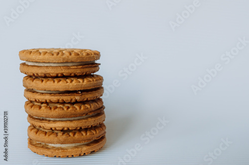 broken cookies with crumbs lies on a brown table on a white backgroundbroken cookies with crumbs lies on a brown table on a white background