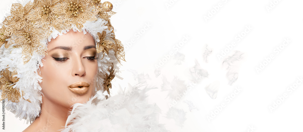 Beautiful winter fashion girl with a creative white and gold Christmas hairstyle blowing a kiss Beautiful winter fashion girl with a creative white and gold Christmas hairstyle blowing a kiss
