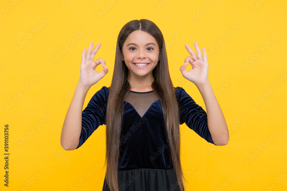 All right and alright. Child show OK signs yellow background. Happy girl smile with satisfaction. Agreed and acceptable. Agreement and permission. Everything is all right All right and alright. Child show OK signs yellow background. Happy girl smile with satisfaction. Agreed and acceptable. Agreement and permission. Everything is all right
