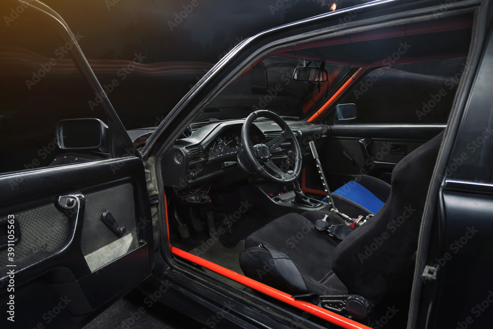sports car interior with roll cage and drift handbrake night photography