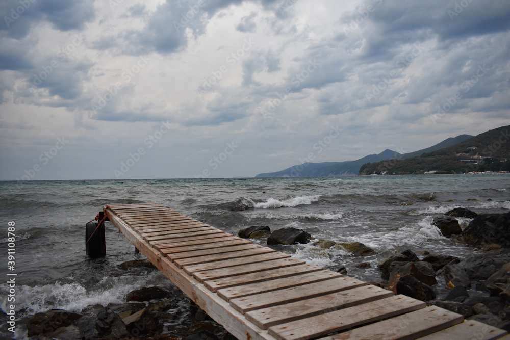 wooden bridge leading to the sea