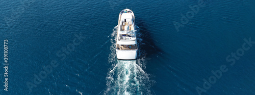 Aerial drone ultra wide panoramic photo of luxury yacht with wooden deck anchored in Mediterranean seascape