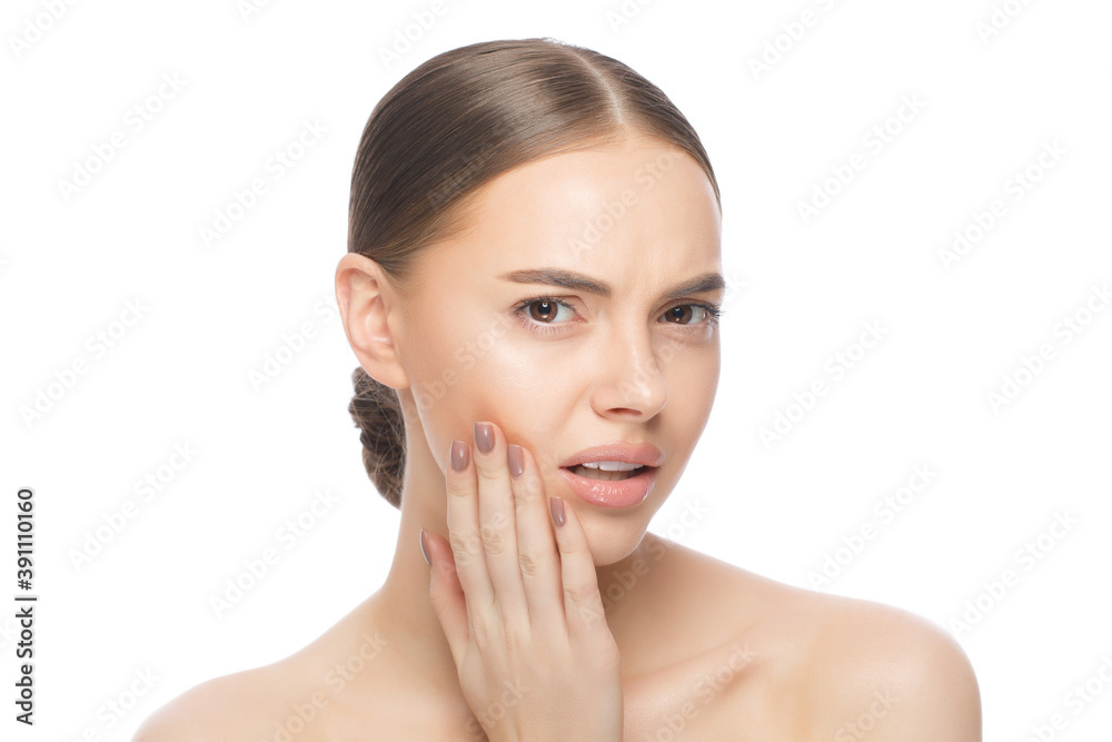 Young woman suffering from tooth ache, pressing hand to jaw trying to overcome pain, isolated on white background