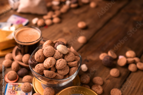 Espresso coffee and Traditional sweets, cookies pepernoten on a wooden table. Copy space. Dutch holiday Sinterklaas. High quality photo. 