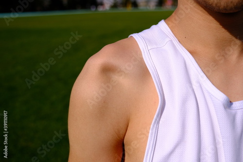 sportsman with shoulder dislocation in turf/sports field. shoulder bone is clarified.  photo