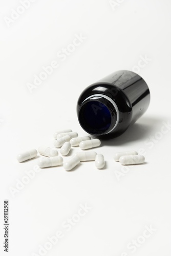 capsule pills with bottle isolated on white background