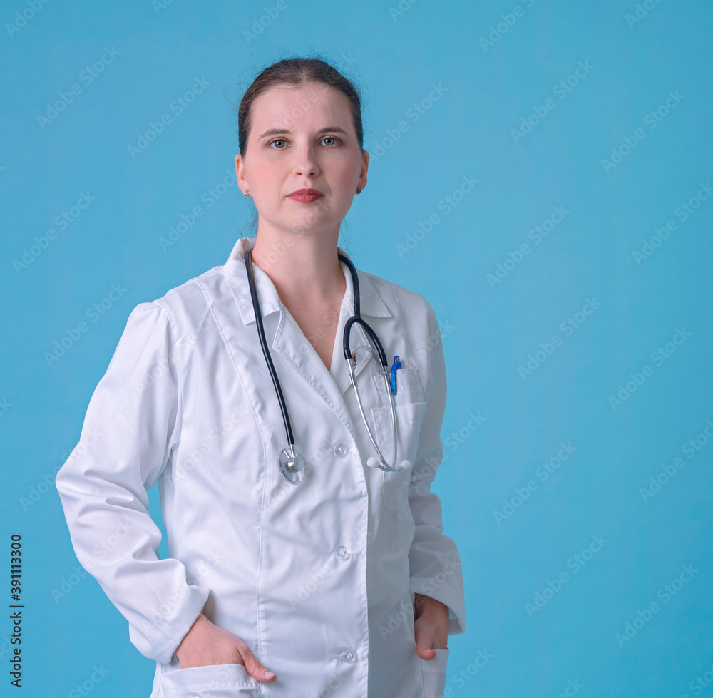 Head shot portrait woman doctor looking at camera, young female wearing white uniform with stethoscope. Female doctor wearing white coat, stethoscope on shoulders Head shot portrait woman doctor looking at camera, young female wearing white uniform with stethoscope. Female doctor wearing white coat, stethoscope on shoulders