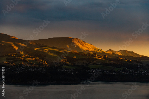 Sunset over a mountain range with a fjord in New Zealand