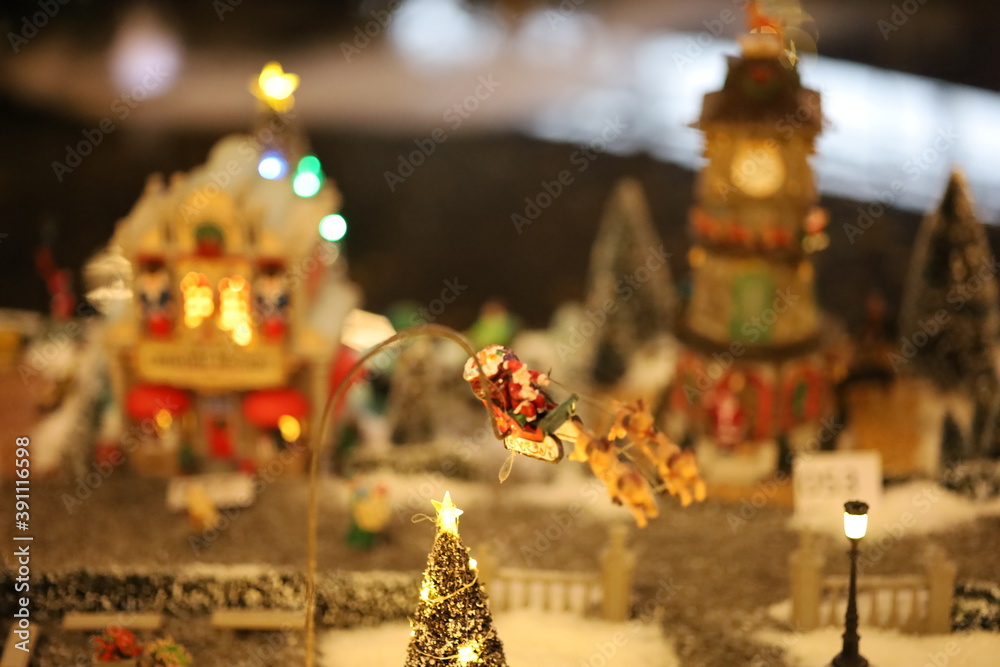 Fototapeta premium Miniature of Christmas scene old house in snow with winter concept, street, outdoor Christmas holidays