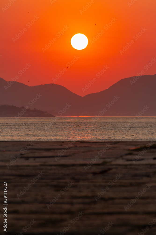 sunrise at the red beach of urca in rio de janeiro.