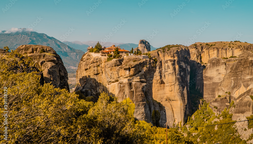 Beautiful panoramic sunset view of the Monastery of the Holy Trinity in Kalambaka, Meteora, Greece with a winch-operated lift