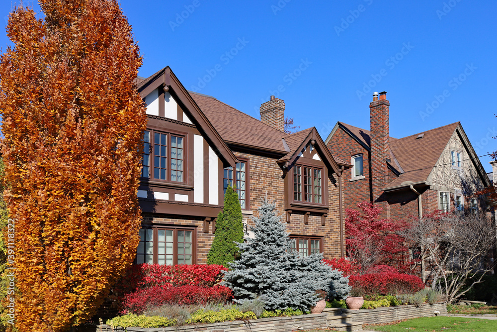 Traditional two story houses with fall colors on a sunny day