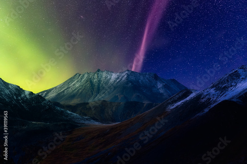 Beautiful Aerial View of Scenic Mountain Landscape in Canadian Nature. Night Star Sky with Northern Lights. Taken near Grizzly Lake in Tombstone Territorial Park, Yukon, Canada.
