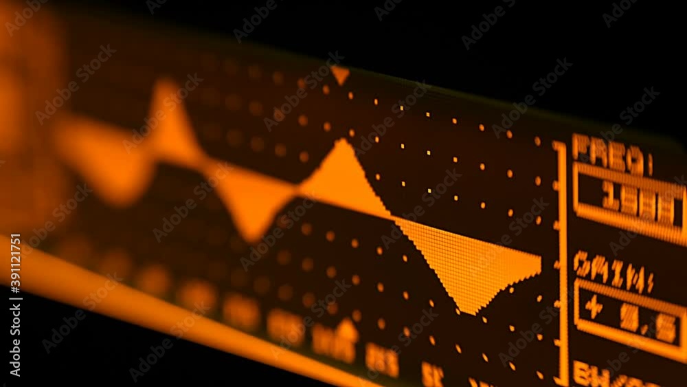 The professional concert parametric equalizer has a yellow spectrum analyzer on the display that analyzes the frequency range of music or any sound and can change it. Closeup