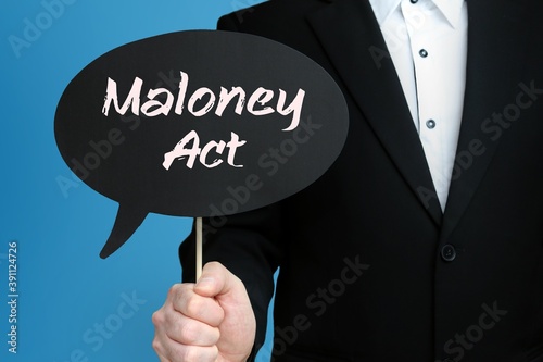 Maloney Act. Businessman holds speech bubble in his hand. Handwritten Word/Text on sign. photo