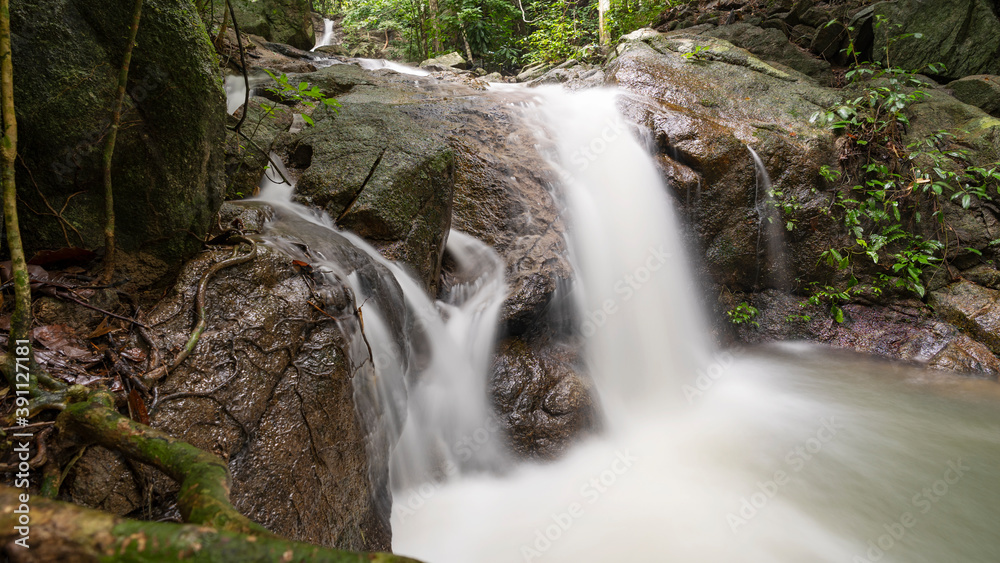 Fototapeta premium Small waterfall in the wild Long exposure image.
