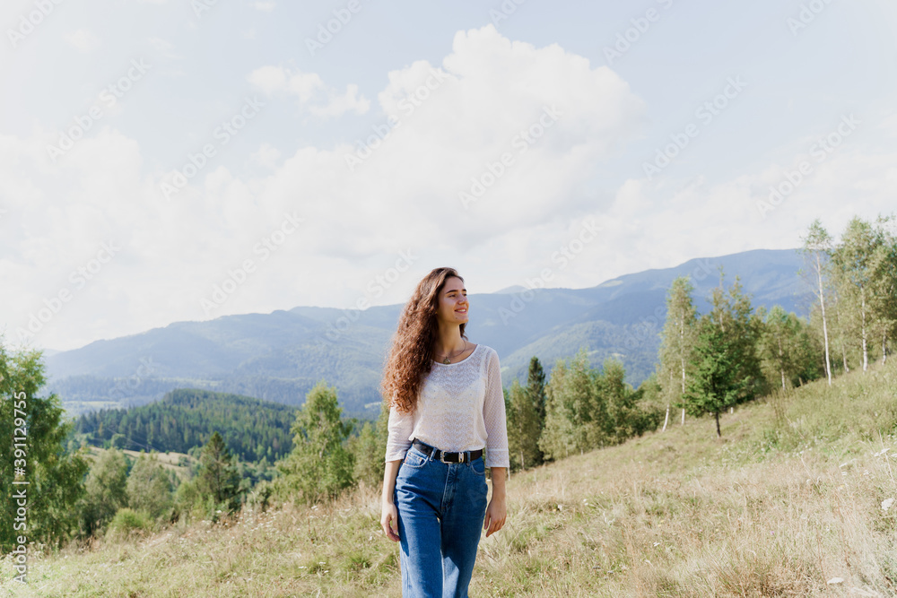 Girl enjoying the mountain hills view. Feeling freedom in Karpathian mountains. Tourism travelling in Ukraine.